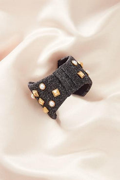 Bow Bracelet Pearls and stud details add dimension to this neoprene bow cuff Grey neoprene bow Stud and pearl details are hand sewn onto neoprene bow 2.25" Fits small to large wrist