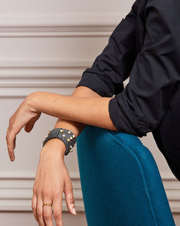 Bow Bracelet Pearls and stud details add dimension to this neoprene bow cuff Grey neoprene bow Stud and pearl details are hand sewn onto neoprene bow 2.25" Fits small to large wrist